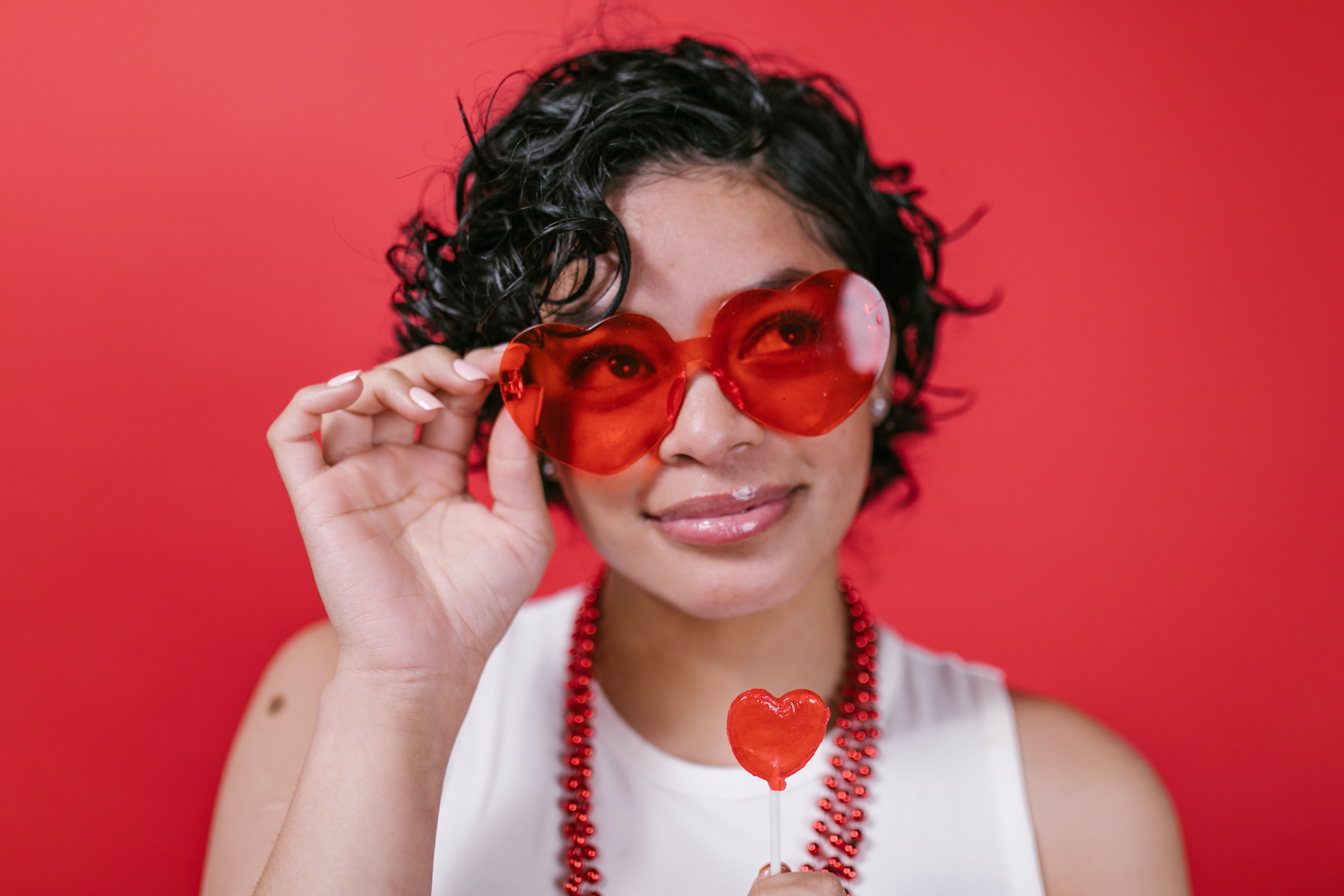 woman wearing heart shaped sunglasses