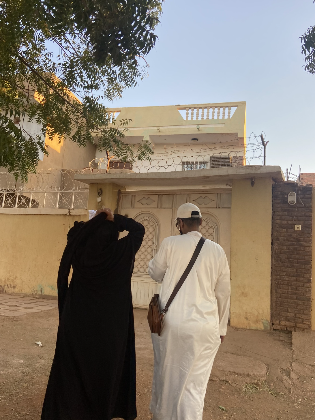 A man and woman are pictured walking in Sudan