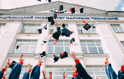 high school graduates throwing their caps