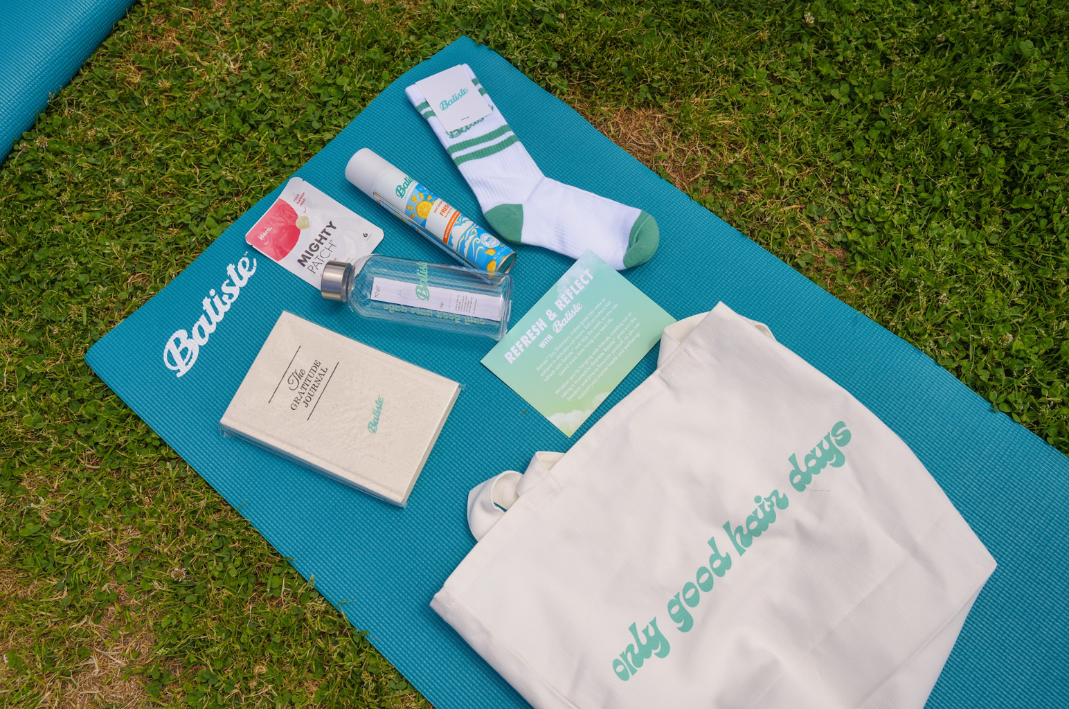 Batiste products on a blue yoga mat.