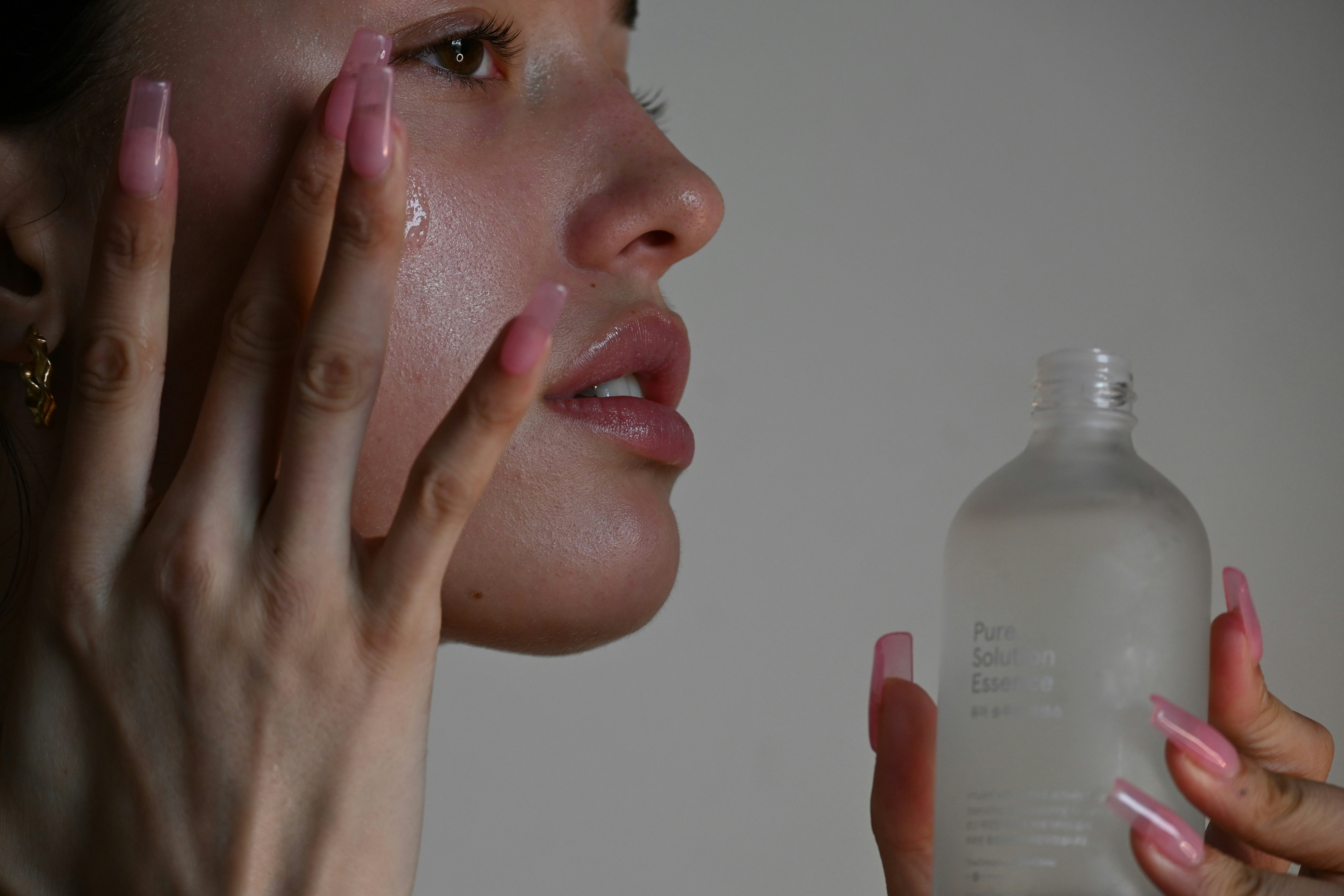 woman putting on a skincare product with her finger