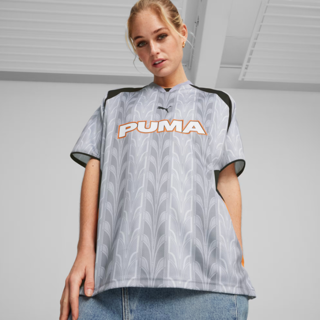 woman wearing a gray soccer jersey with a PUMA logo