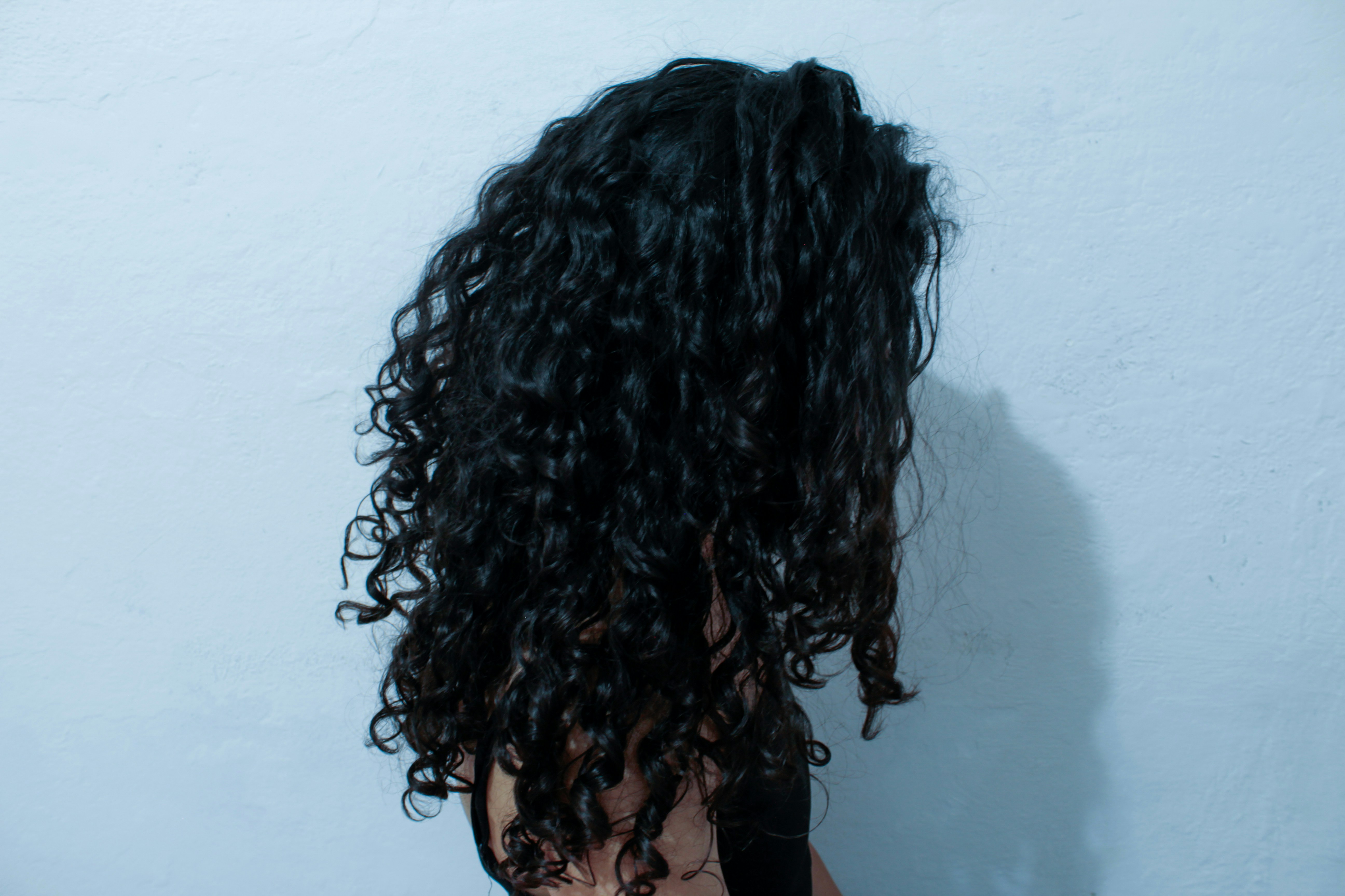 Woman with curly hair facing away