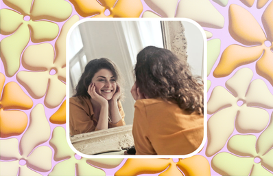 woman smiling at herself in the mirror