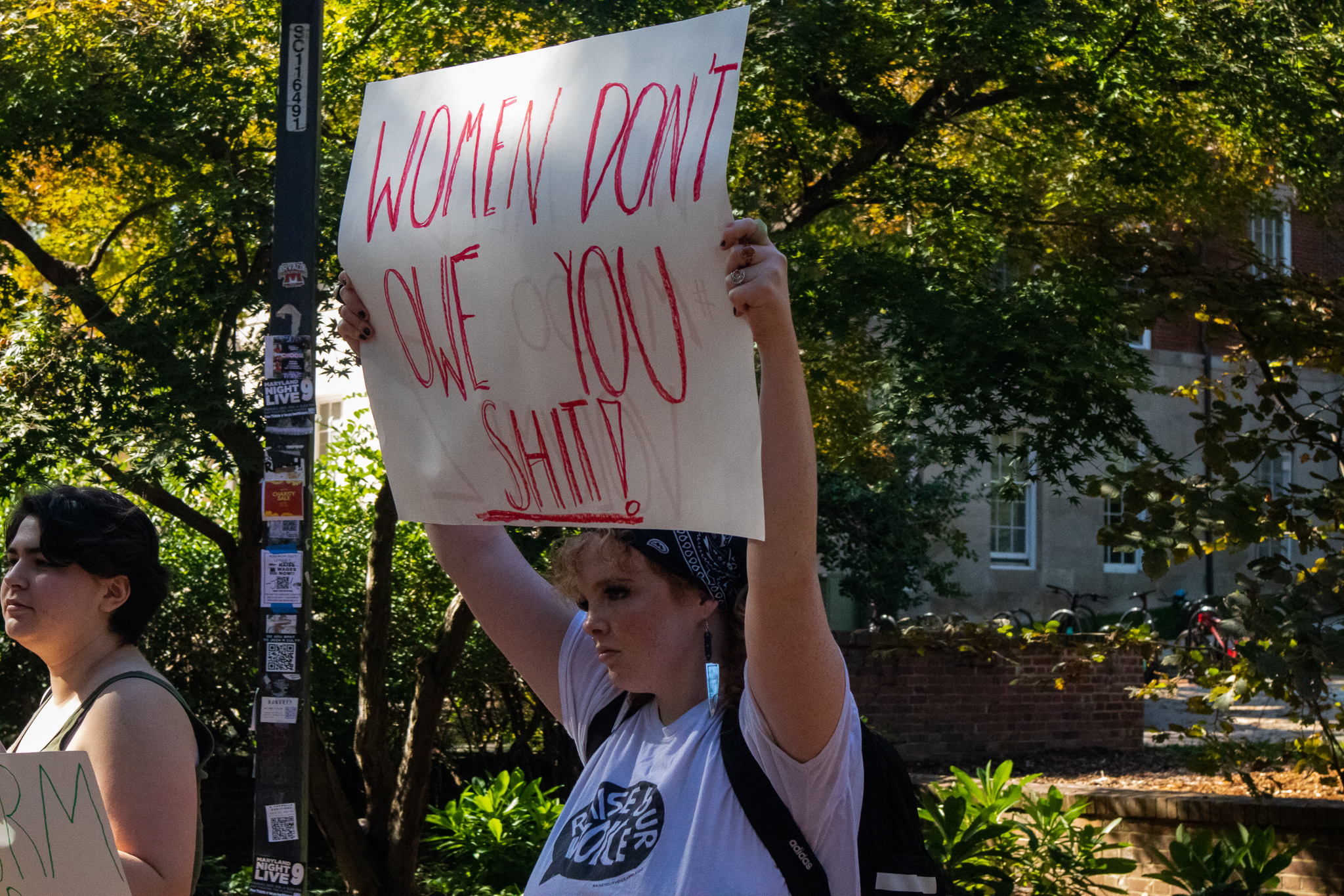A woman holds up a sign at a protest