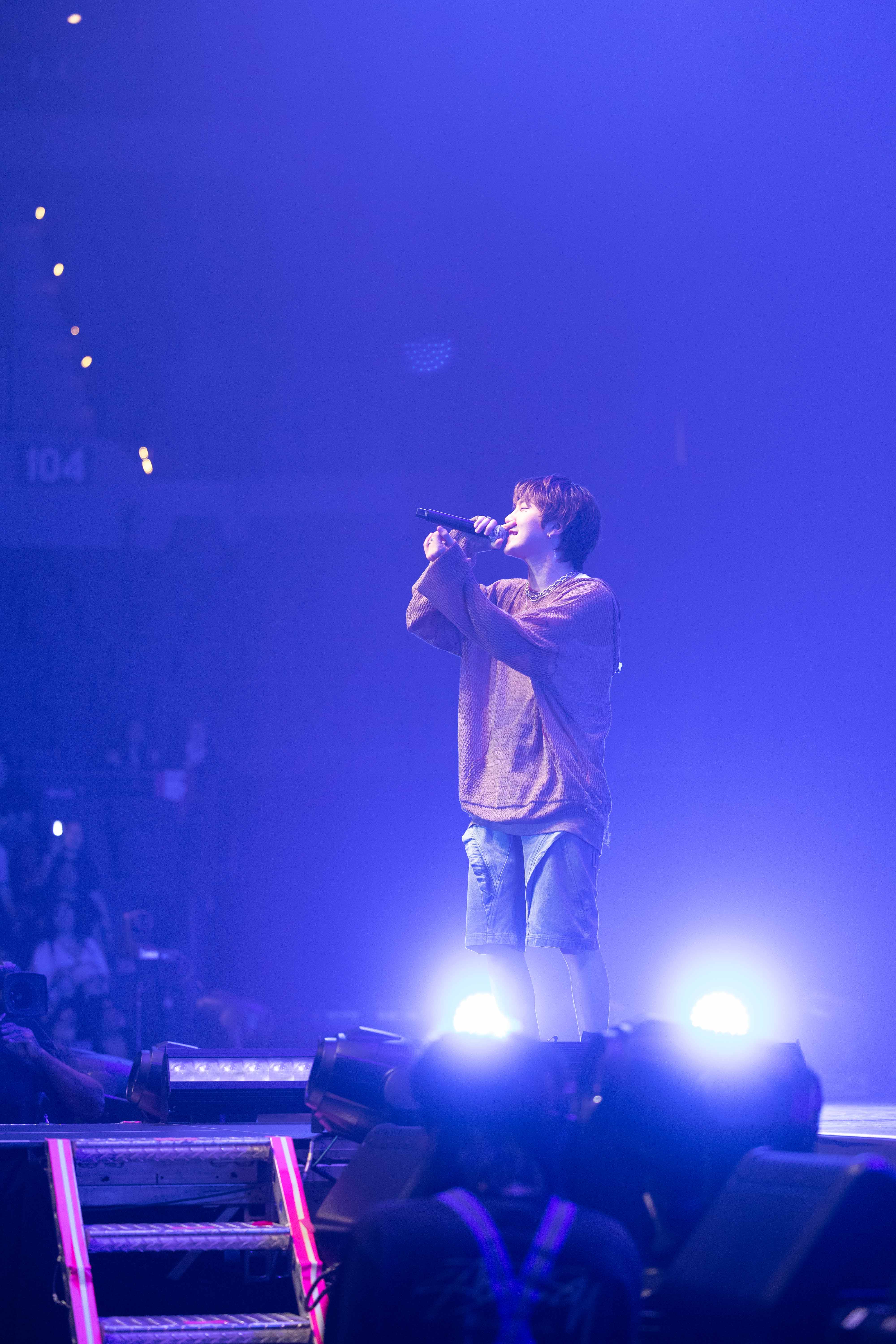 k-pop musician singing on stage