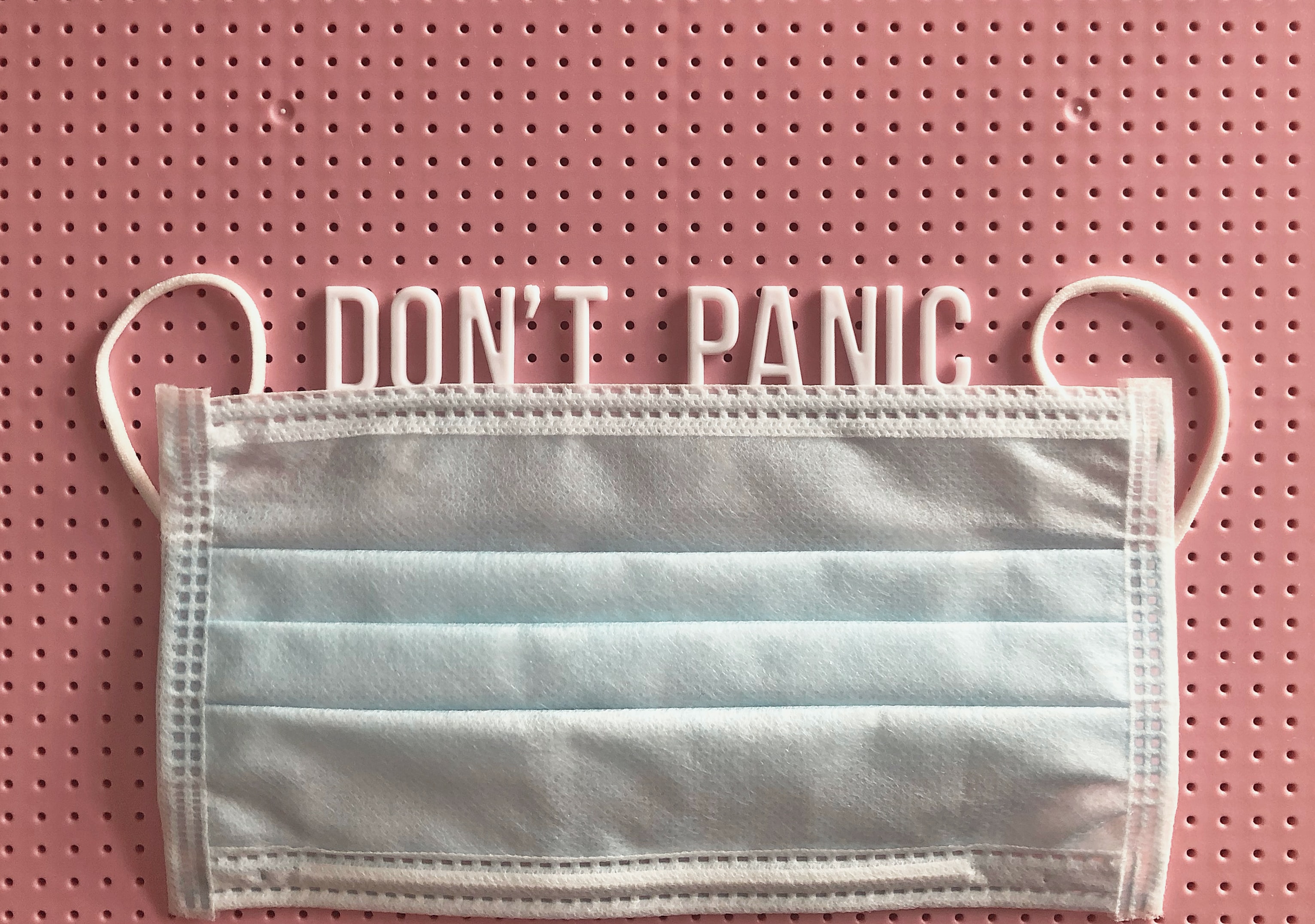 mask with the words dont panic by Tonik via Unsplash