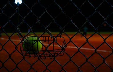 Softball hung on fence