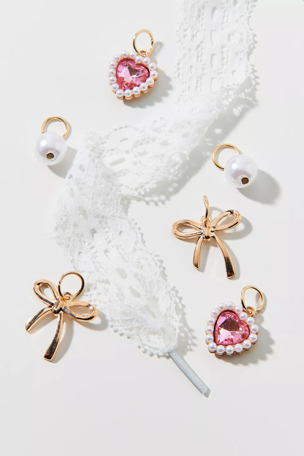 white shoelace and pink and gold charm set