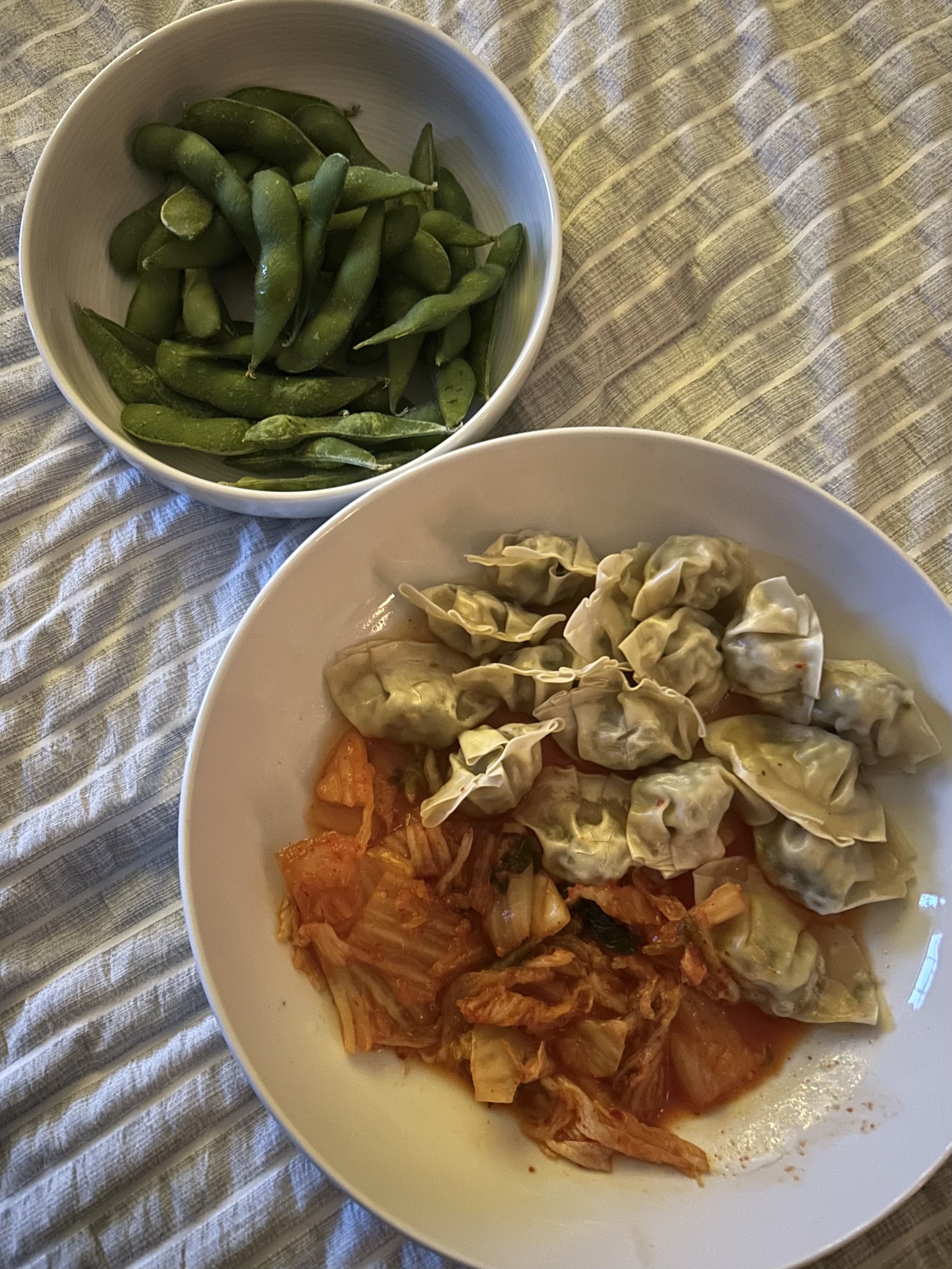 Dumplings, edamame, and kimchi in a bowl
