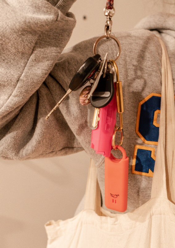 someone in sjsu sweatshirt holding up keys and pepper spray