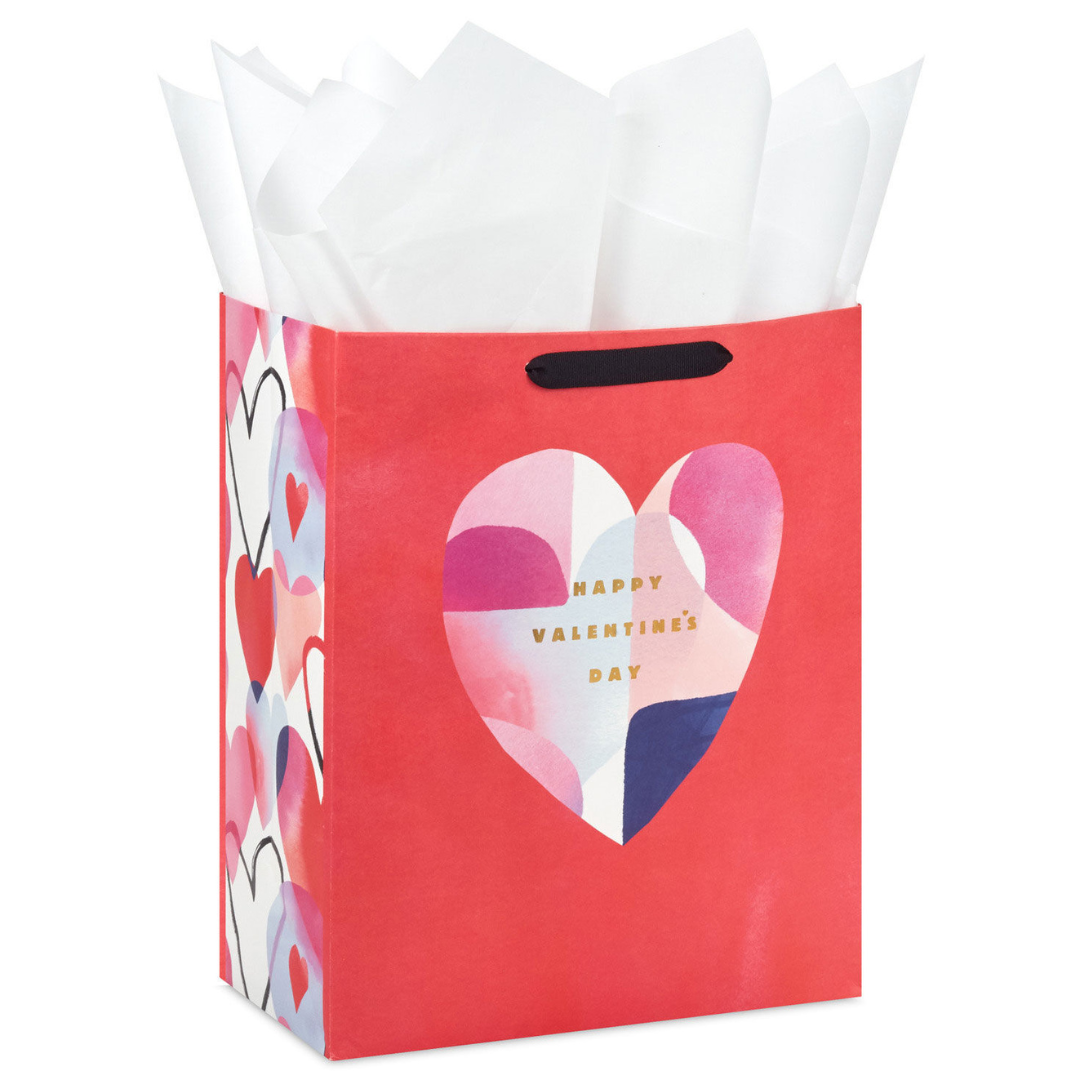 red gift bag with multi-colored heart illustration and text that reads \