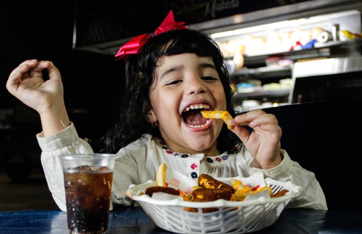 Young girl eating fries