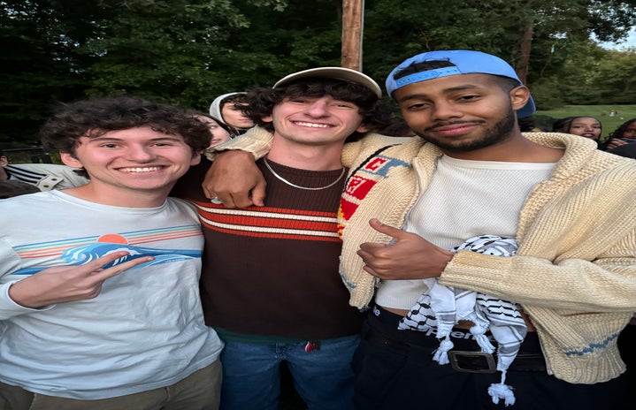 UMD students Dylan Levine, freshman business major, and Leo Shems, freshman public health major, with Mustafa the Poet.