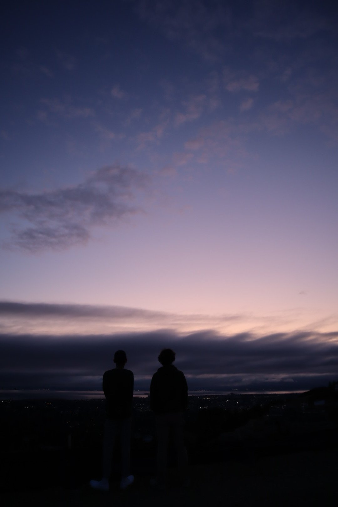 blue sky with two people looking at the sunset