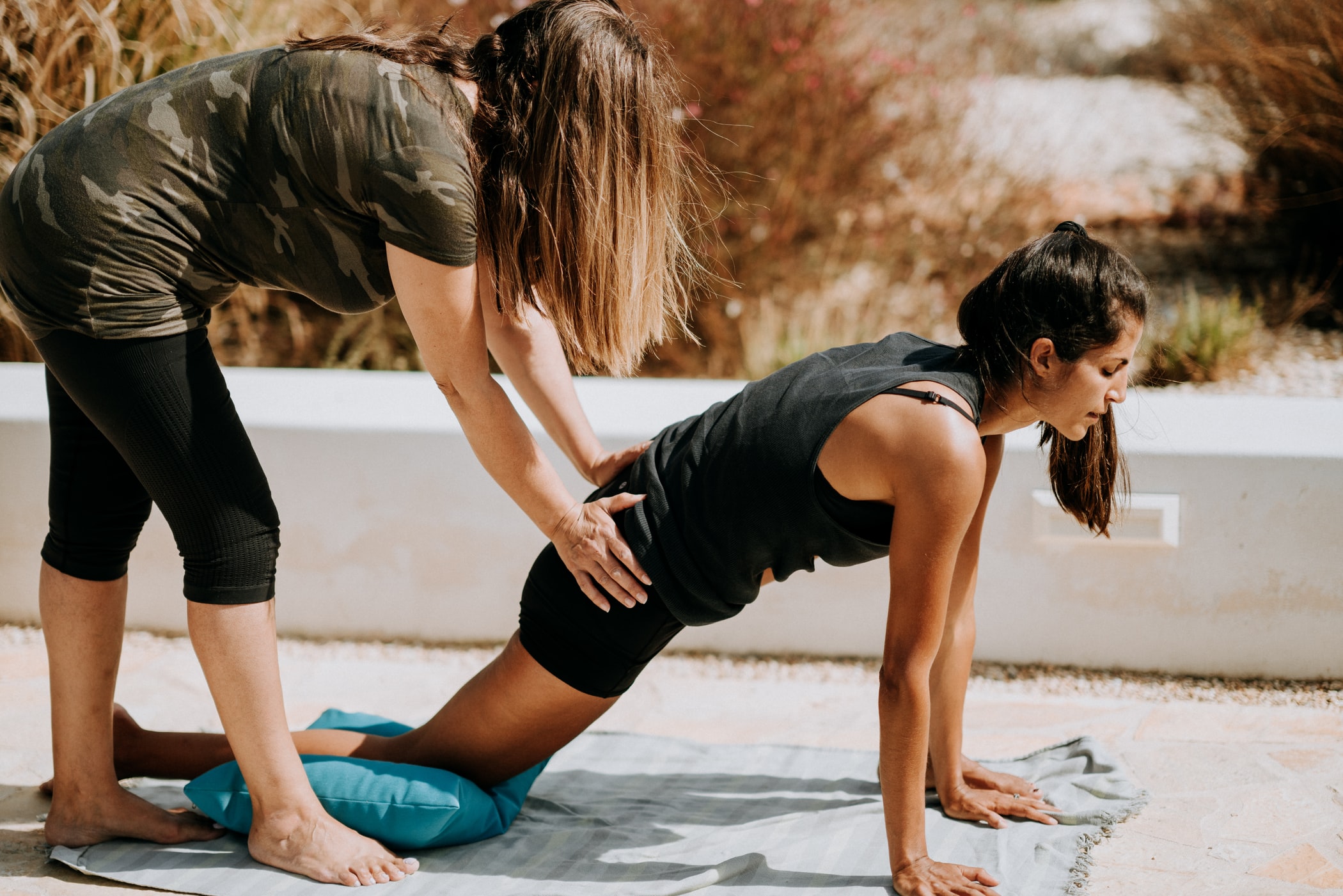 woman instructing another woman with workout
