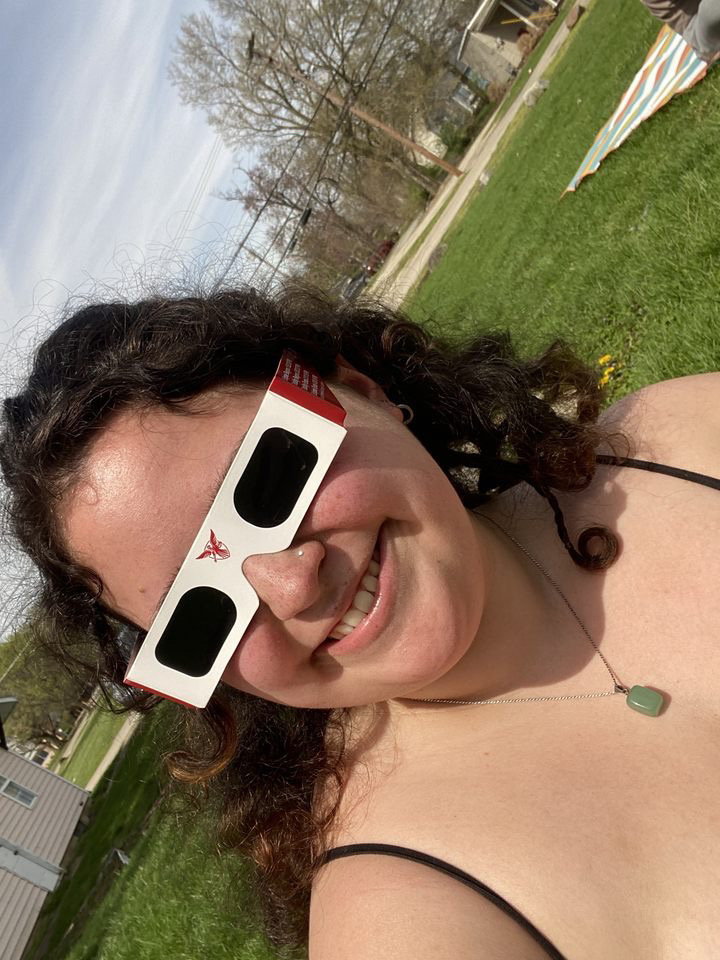 Woman wearing solar eclipse glasses