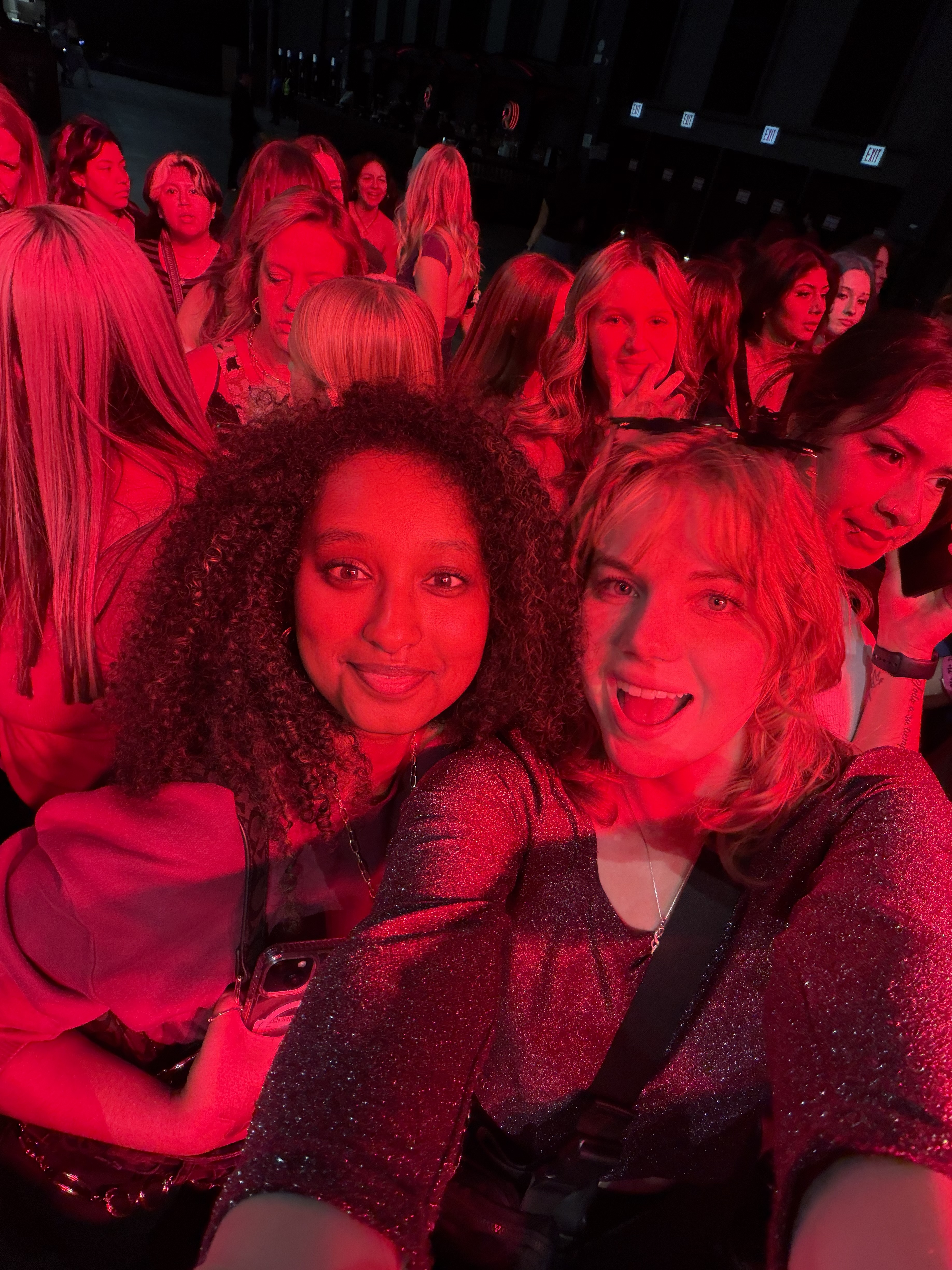 Two girls taking a selfie at a concert