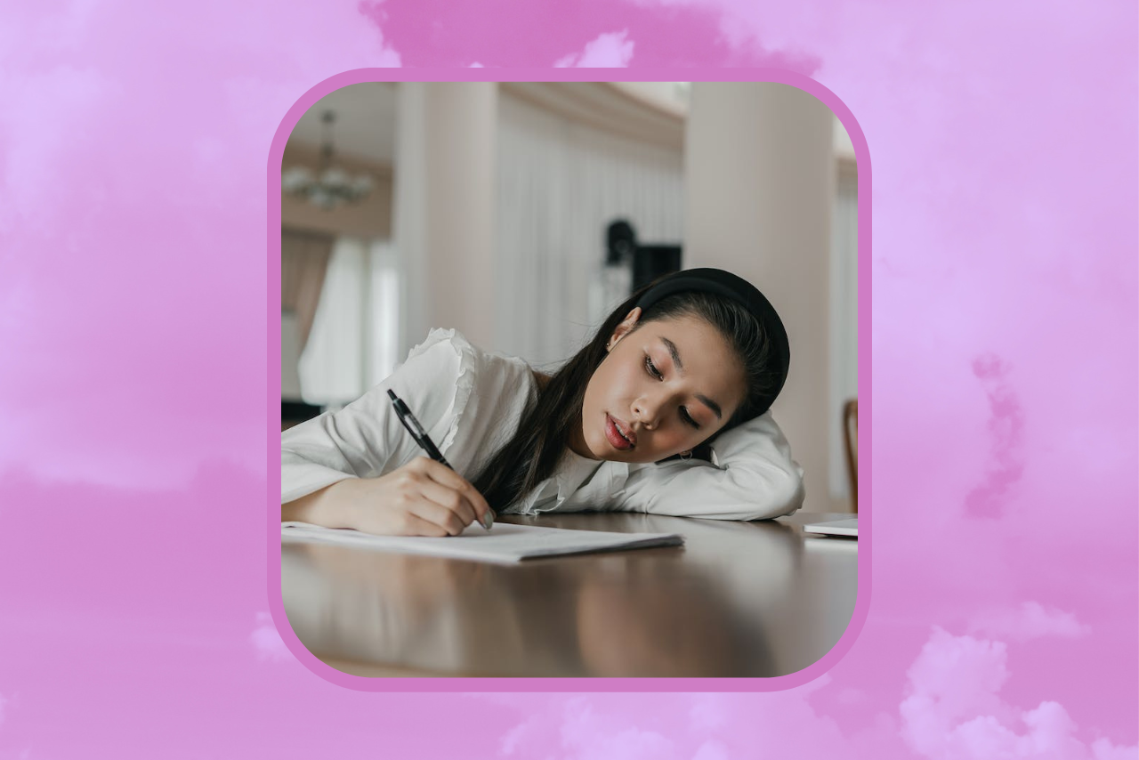 girl writing in notebook and looking stressed