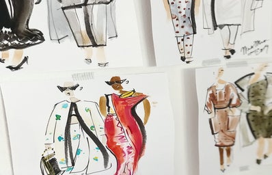 Fashion illustrations taped onto a wall.