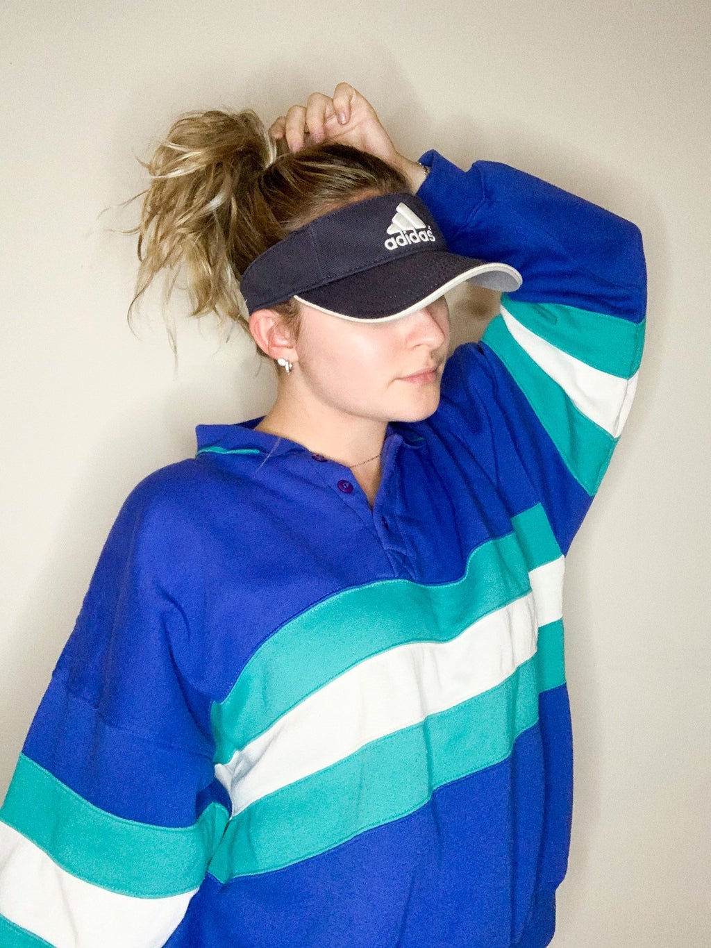 sporting an adidas hat and sweatshirt with white background