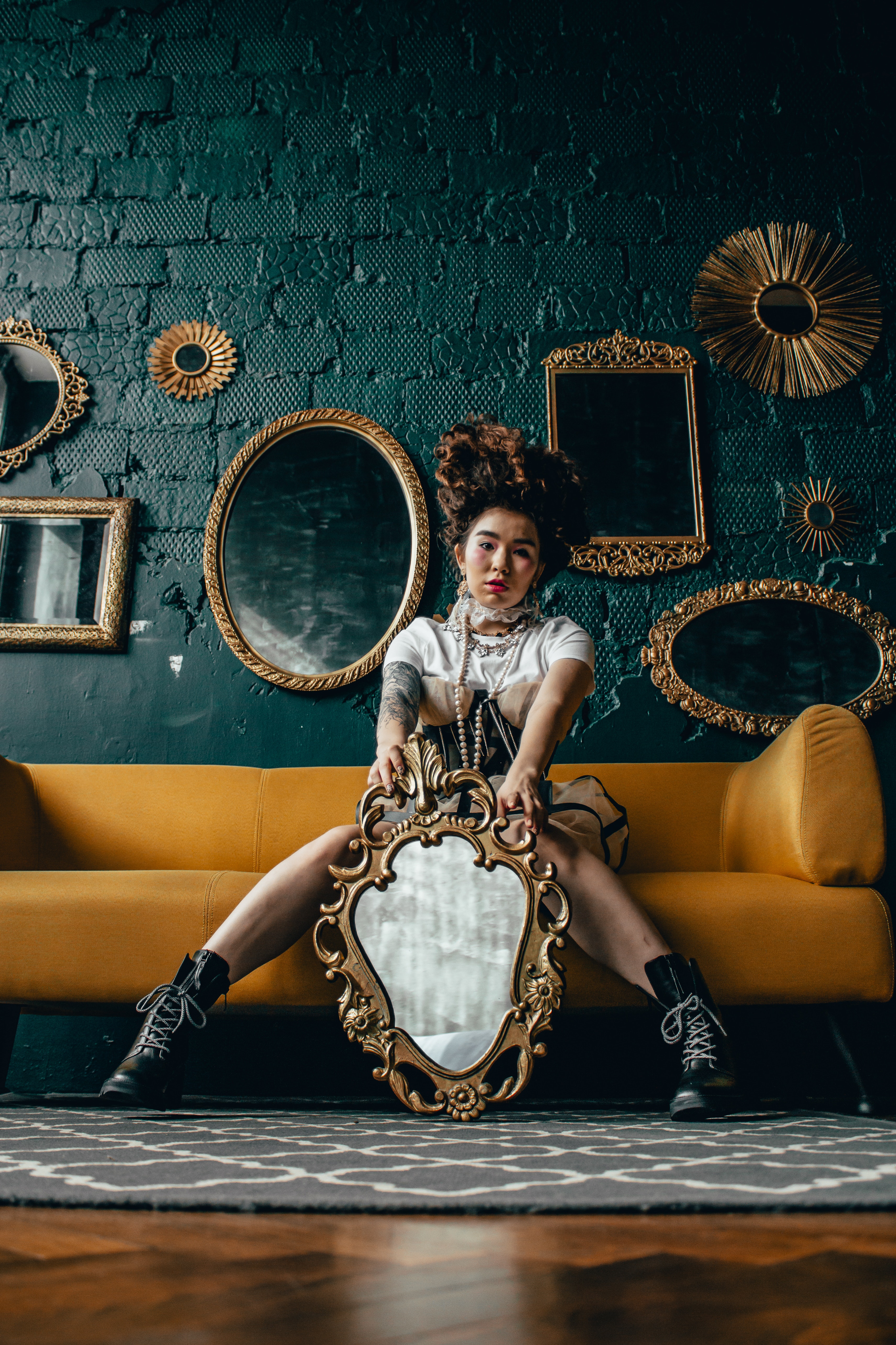 A woman in a dress holding a mirror instead of