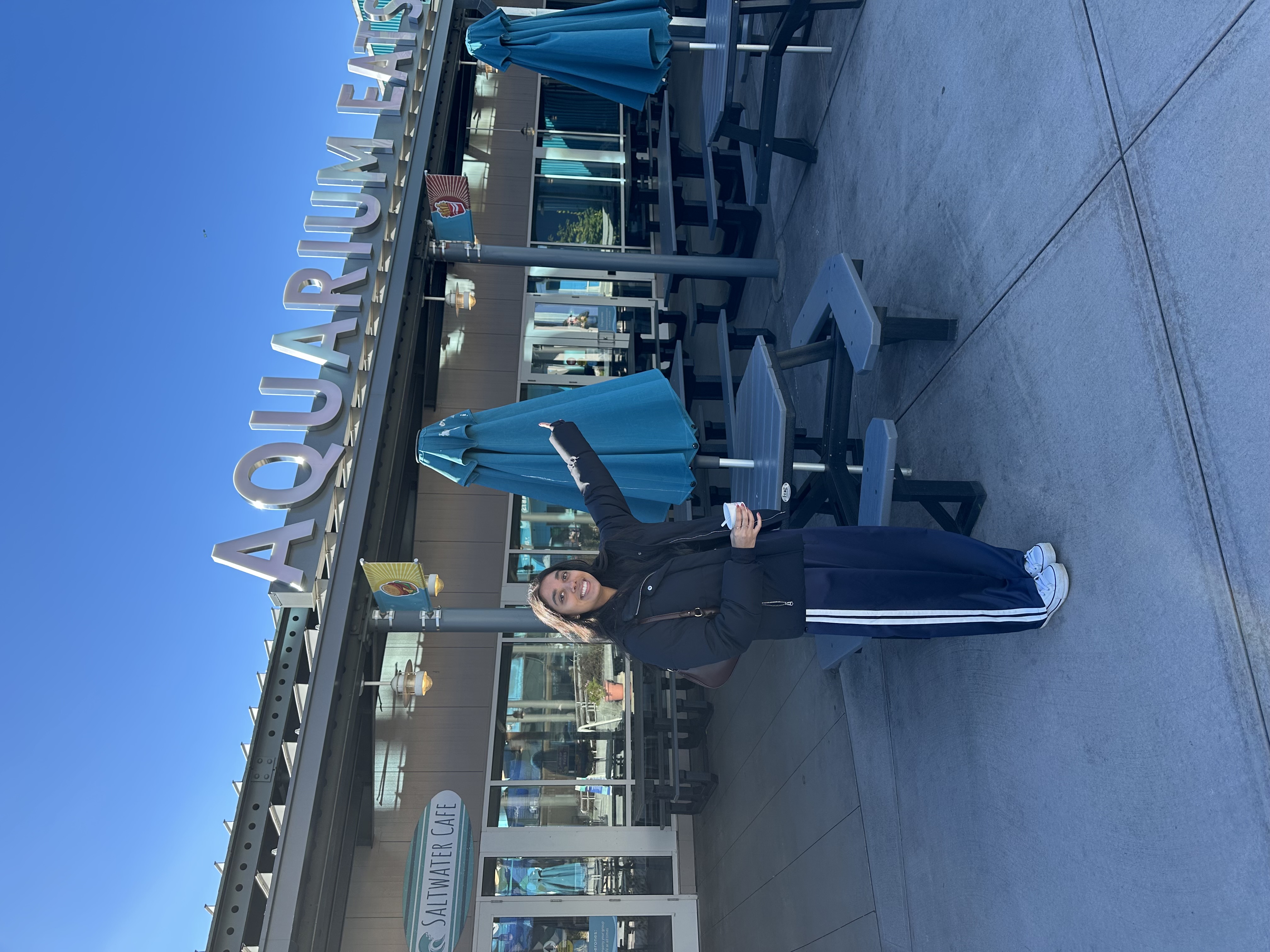 Karishma pointing to cafe