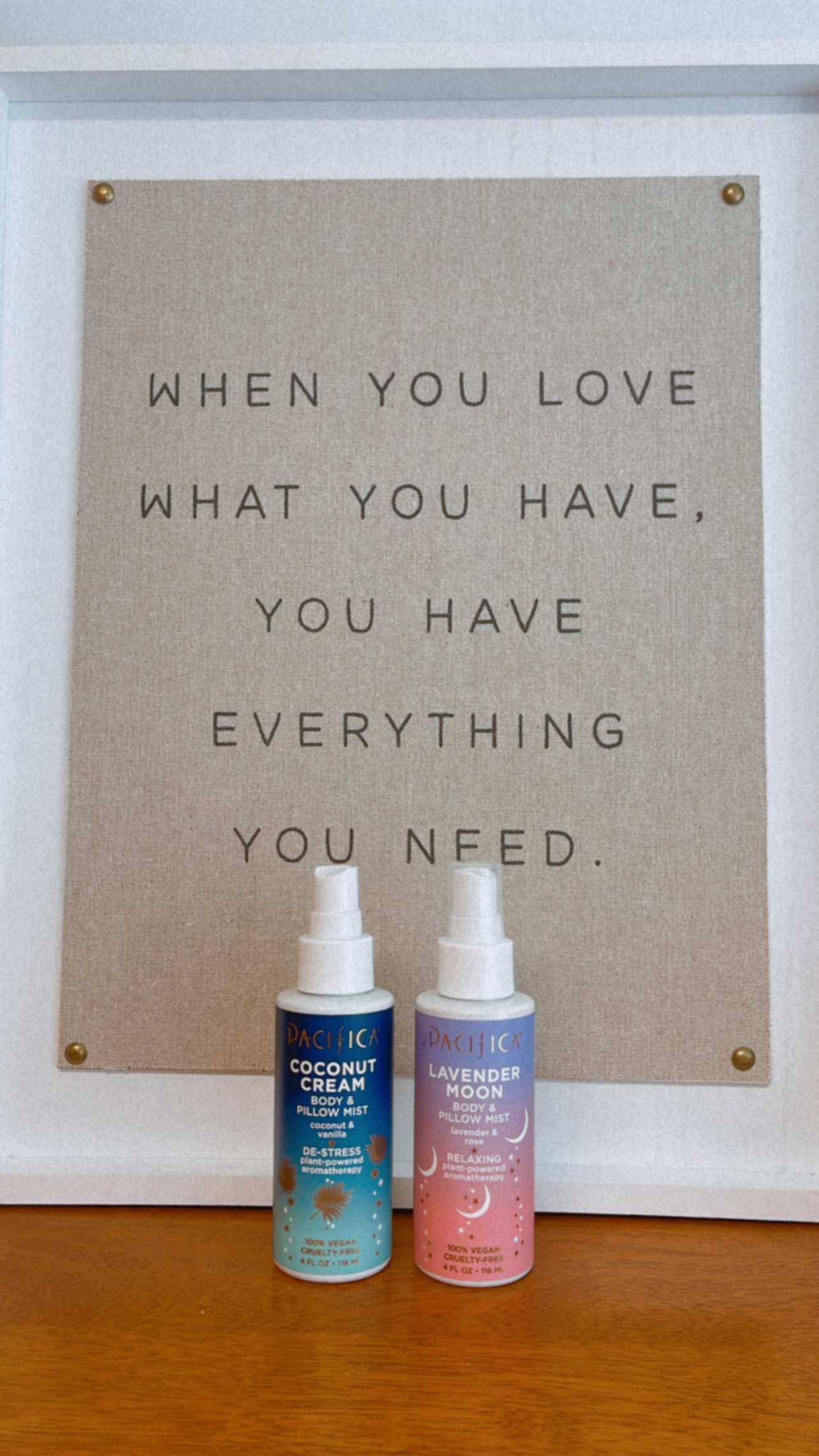 This is an image of both pillow mists together, in front of a sign. I am using this for an article on better sleep habits.