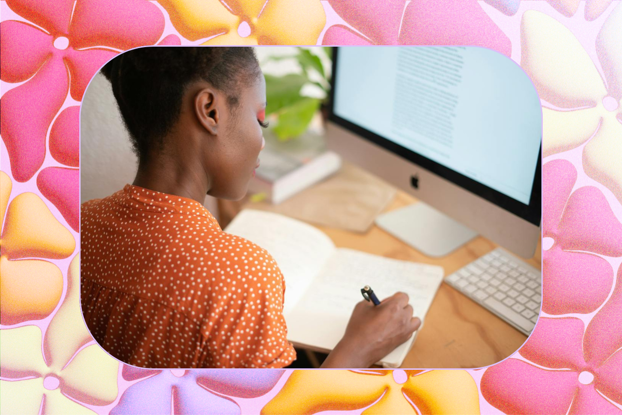 woman writing with a notebook and computer
