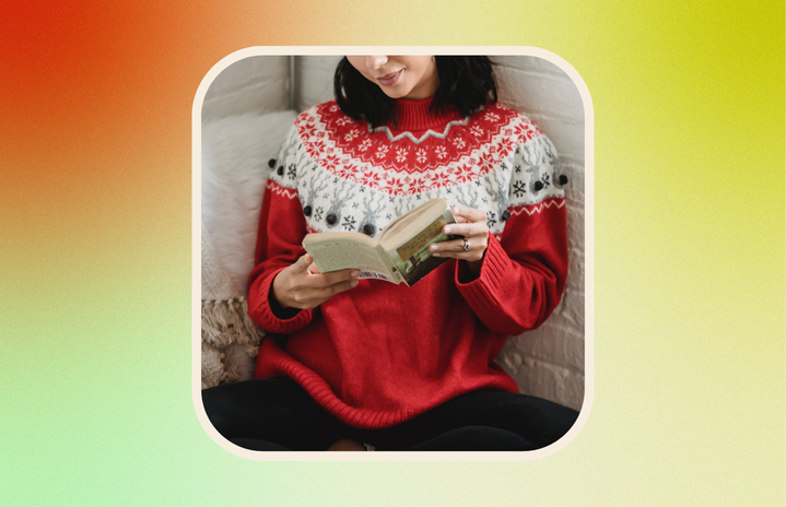 woman reading book in holiday sweater
