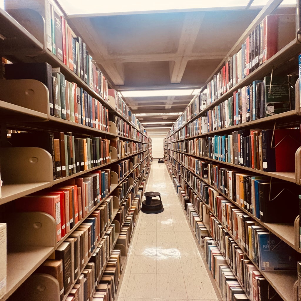Hallway of Library, stacks of books at Hofstra University Axinn Library