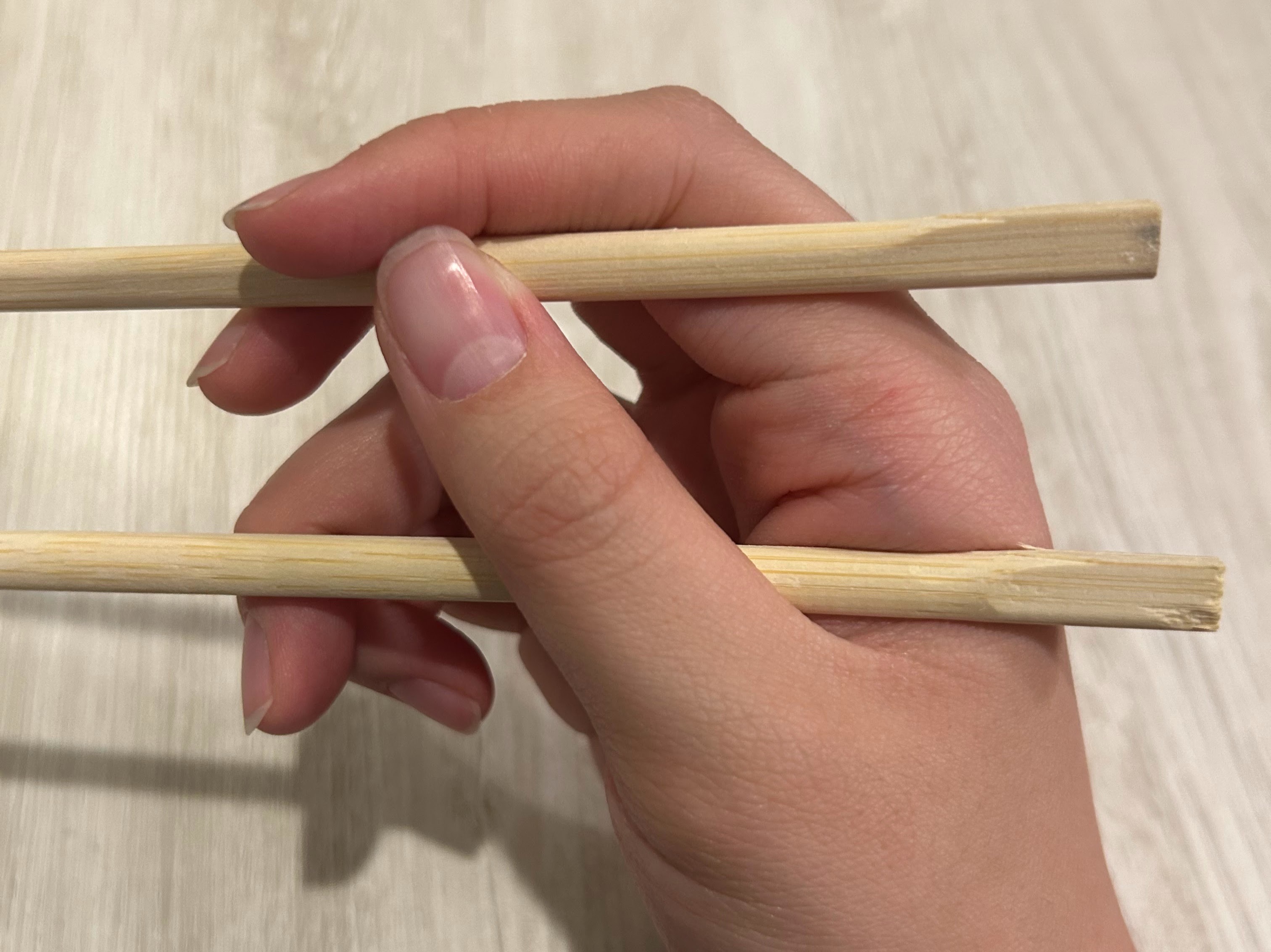 Hand Holding Chopsticks