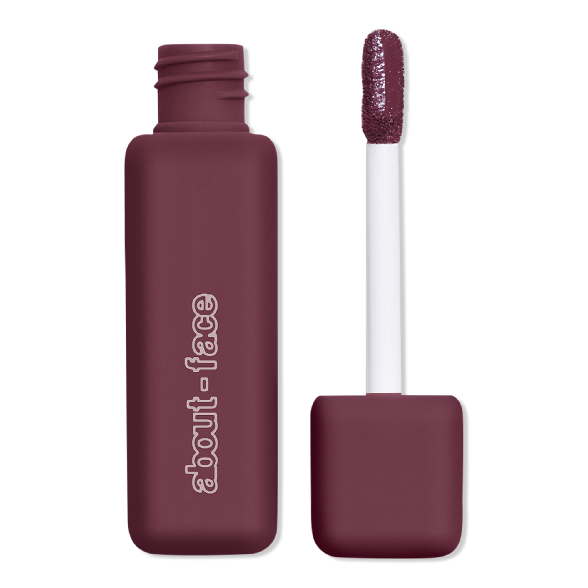 Mauve About-Face liquid lipstick shown with its open applicator wand and glittery berry-colored tip against a black background, evoking a sleek, polished beauty product.