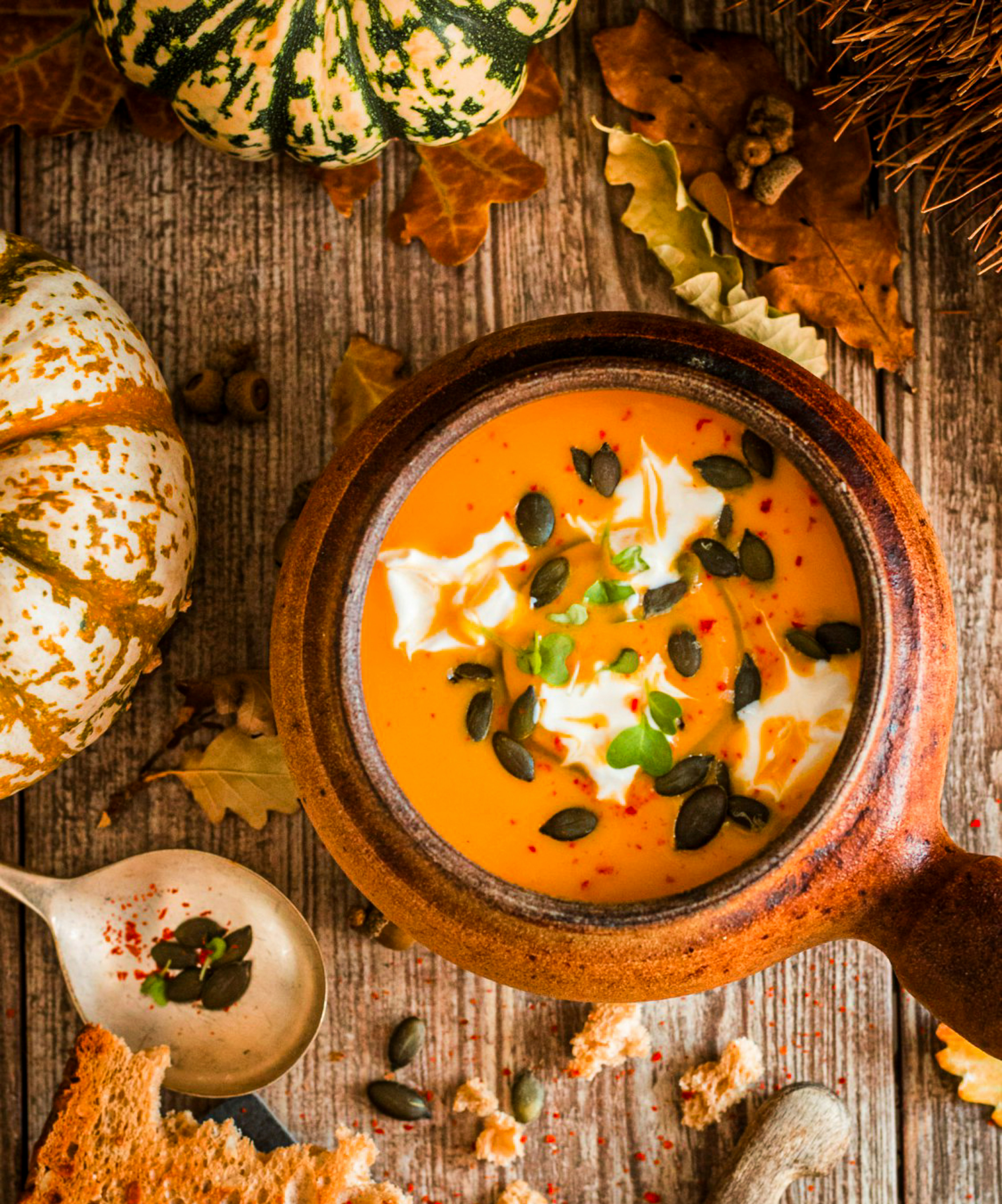 A bowl of soup with pumpkin decor