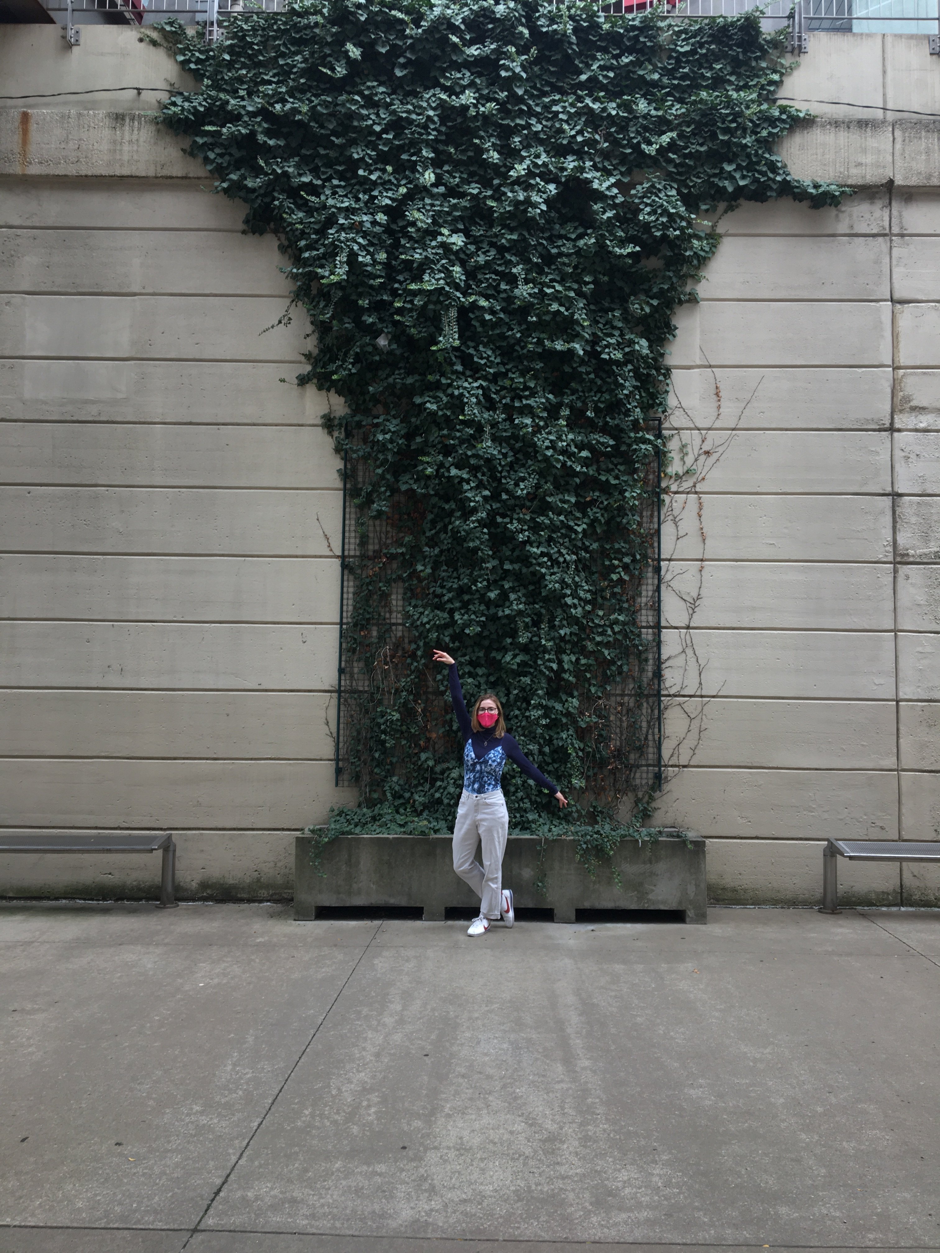 Girl in front of greenery