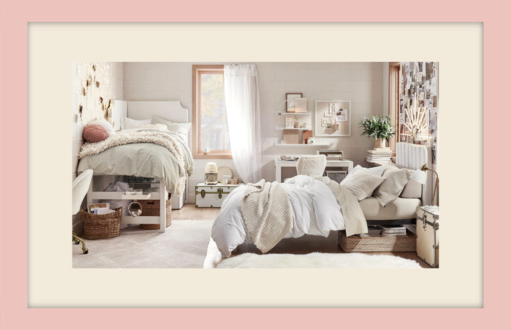 Neutral-colored dorm room with two beds and one window.