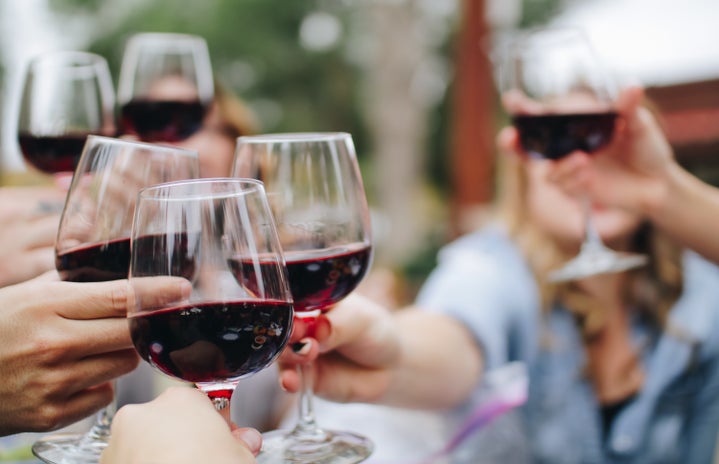 Cheers with red wine glasses