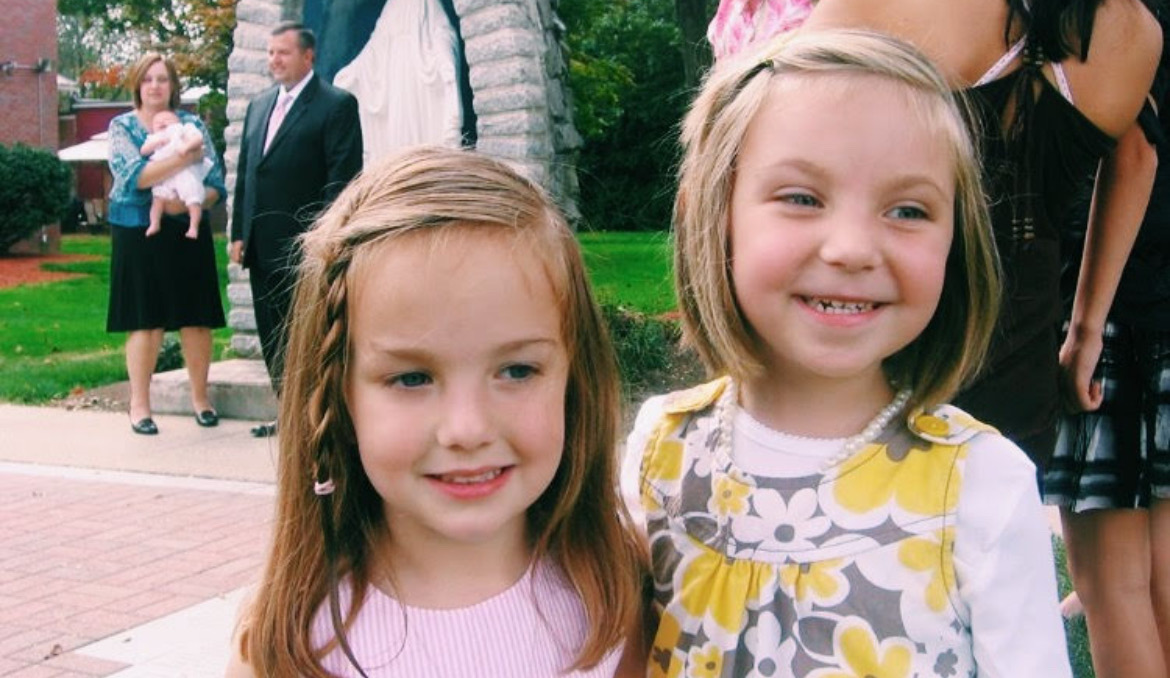 Two little girls smiling together