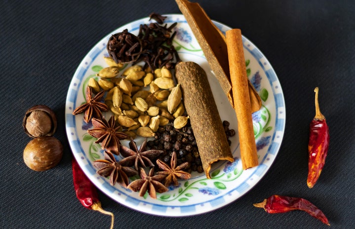 Plate of masala chai spices, including cinnamon and star anise